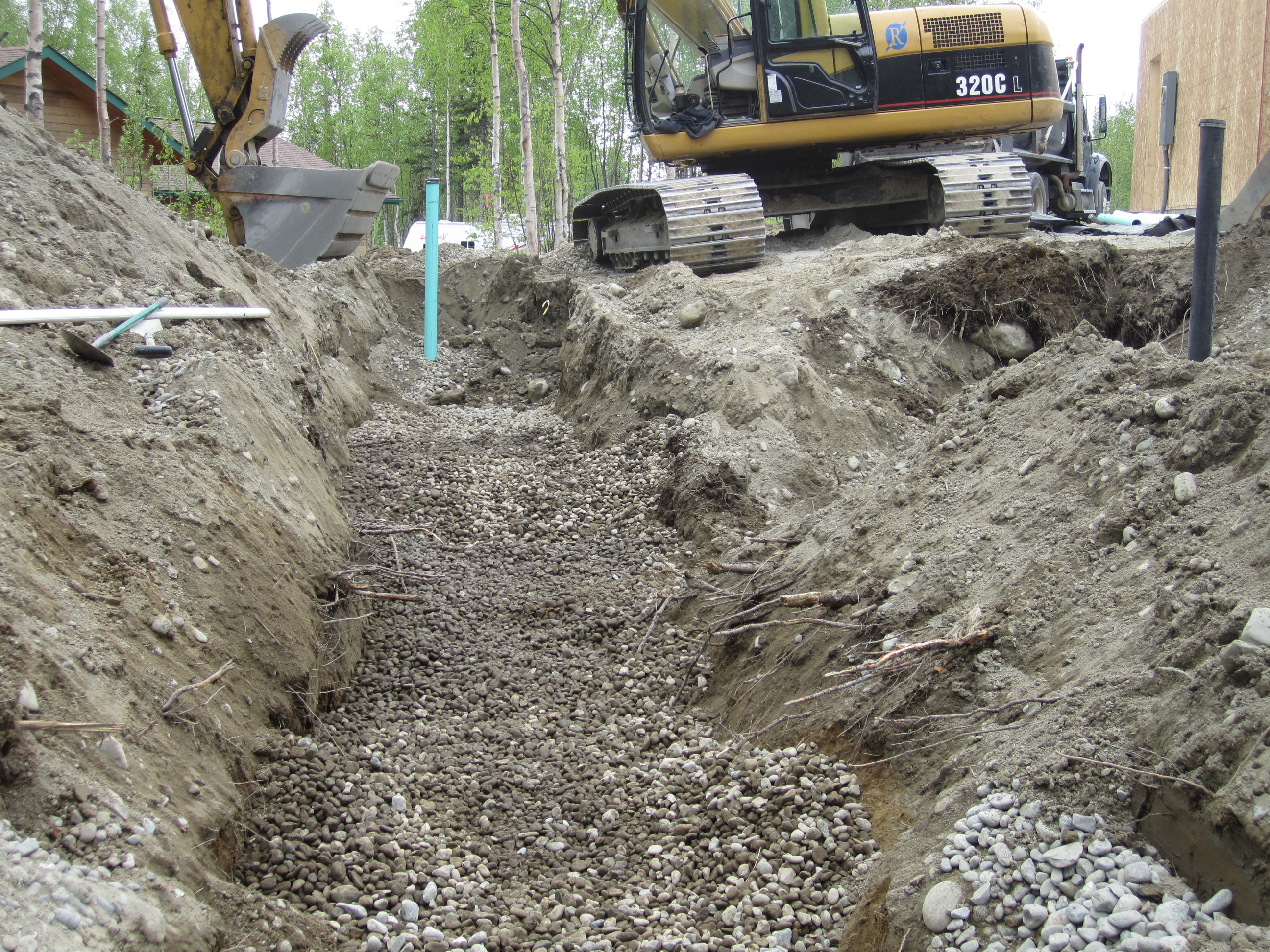Grading a sewer and ensuring proper flow rate.